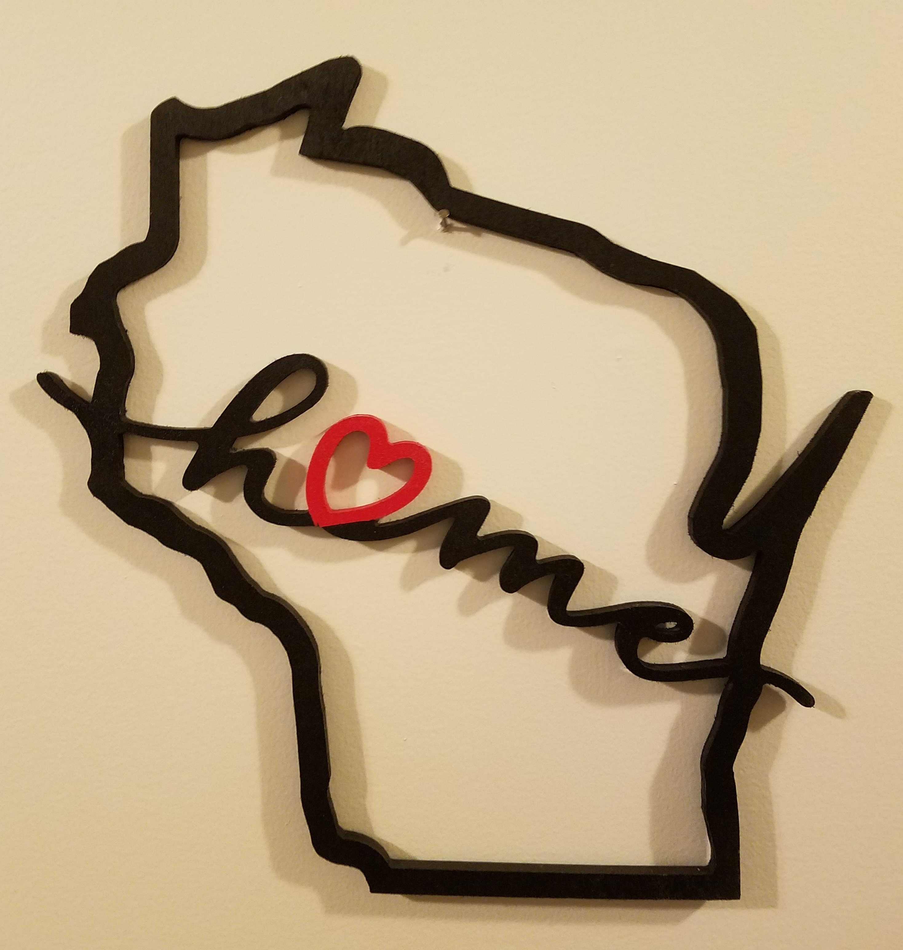 Picture of wooden Wisconsin outline with the word home written across the middle.