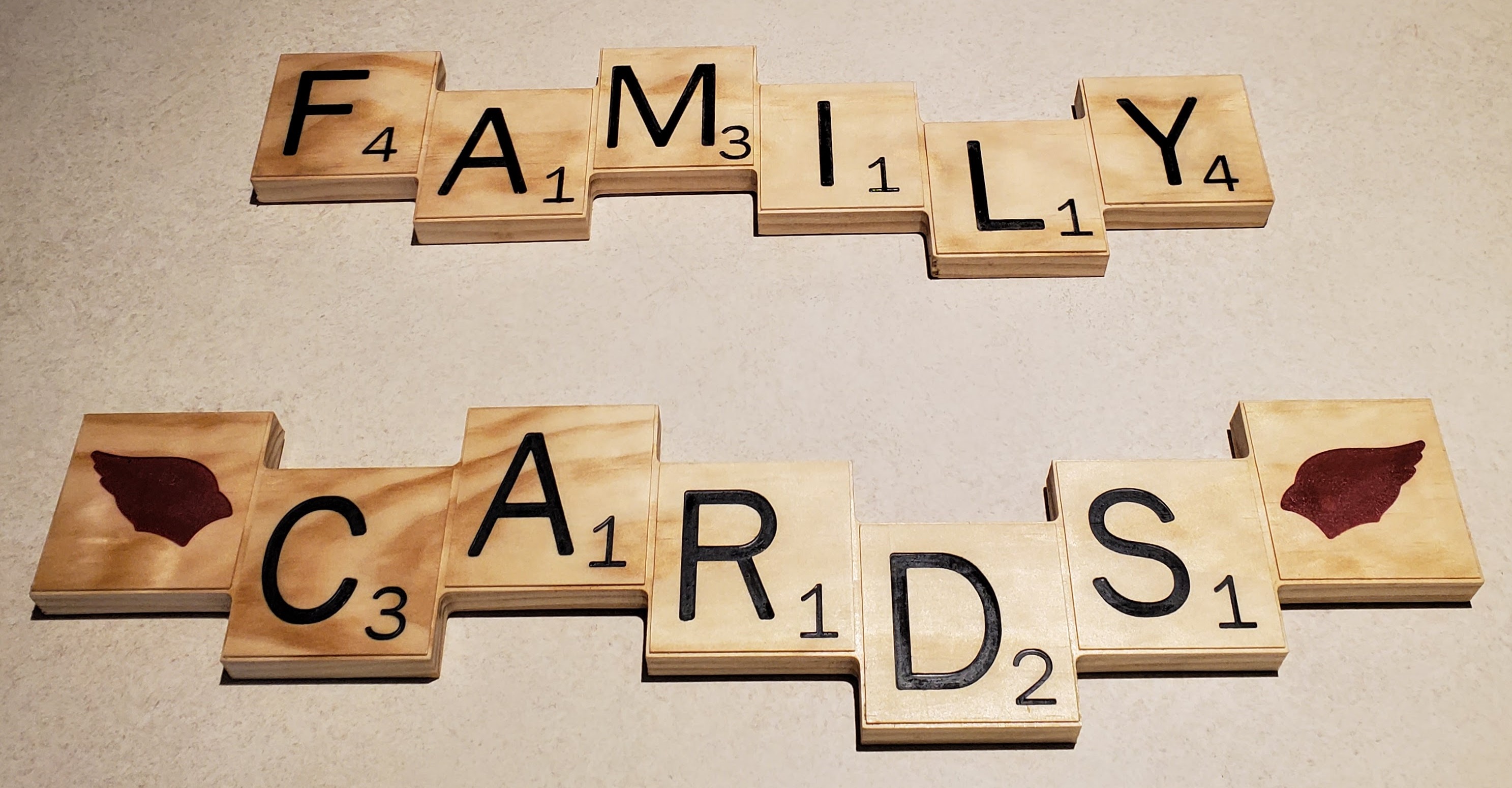 Picture of wooden scrabble tile pieces that spell out family and cards.