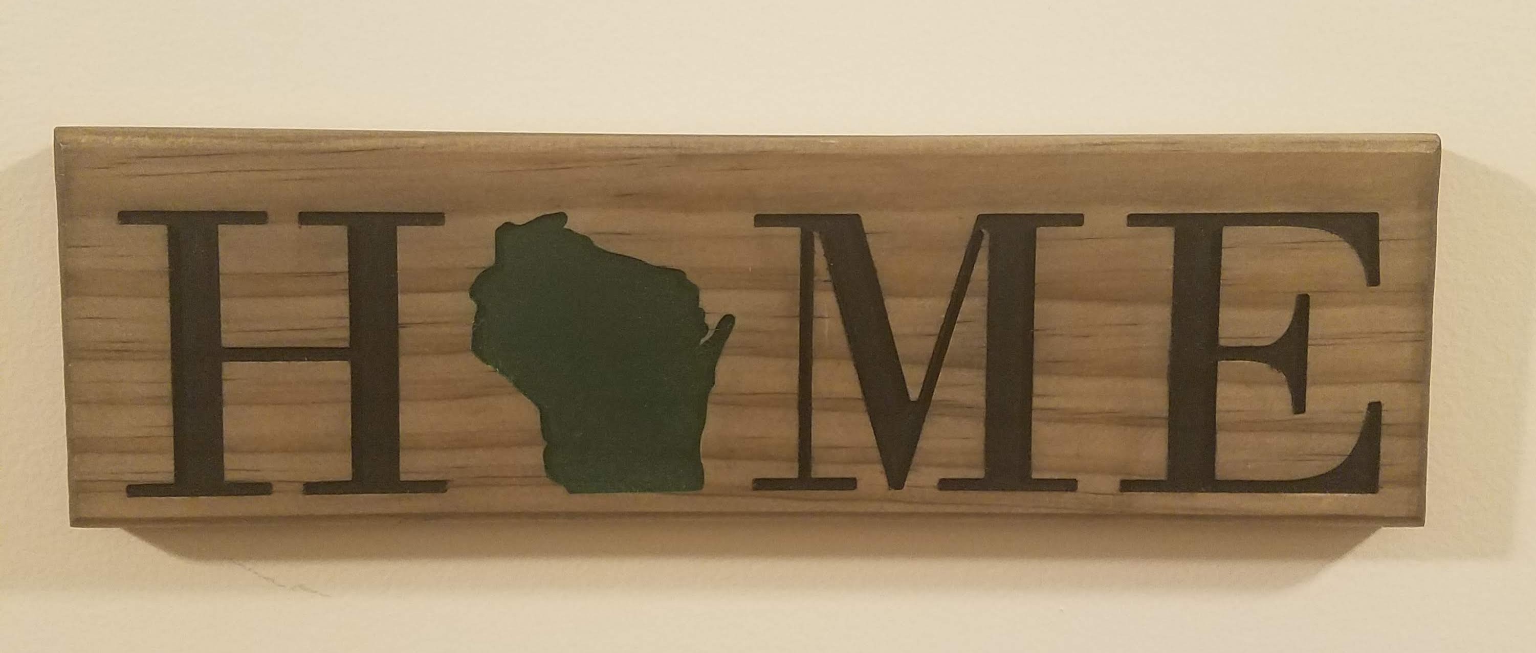 Picture of wooden home sign with WI state as the 'O'.