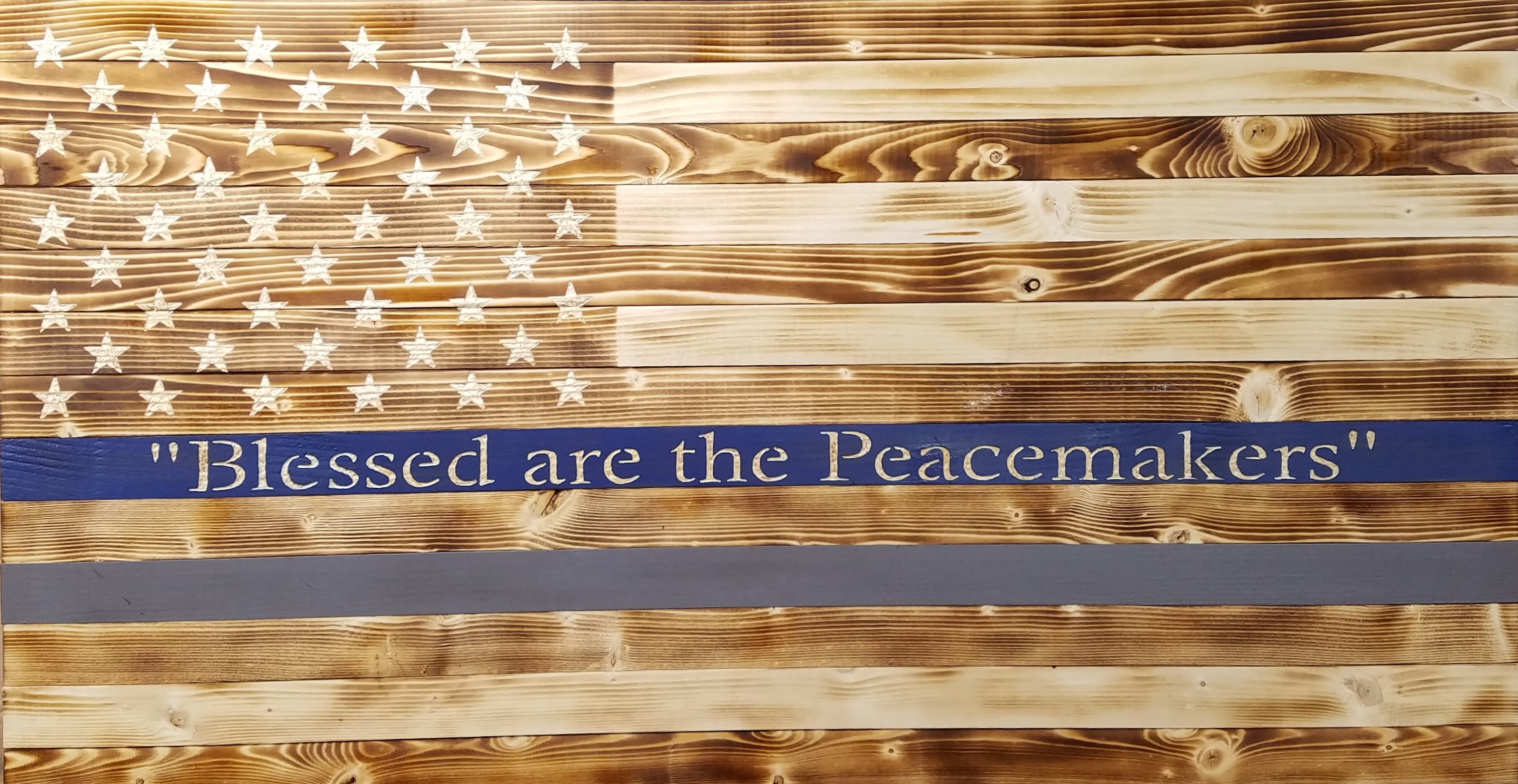 Picture of rustic wooden flag with gray stripe and blue stripe with Bible verse.