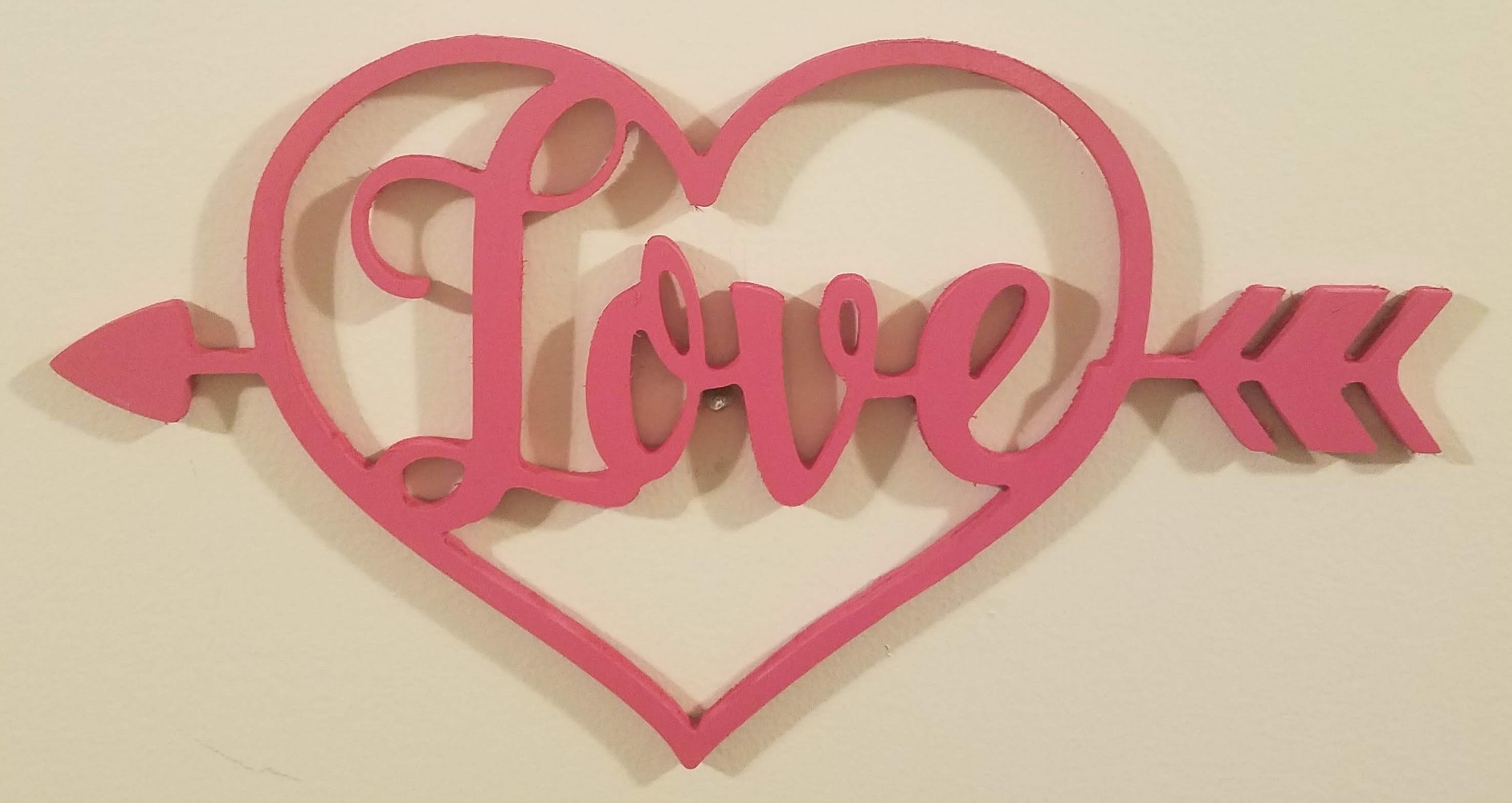 Picture of wooden sign - love word inside a heart and arrow.