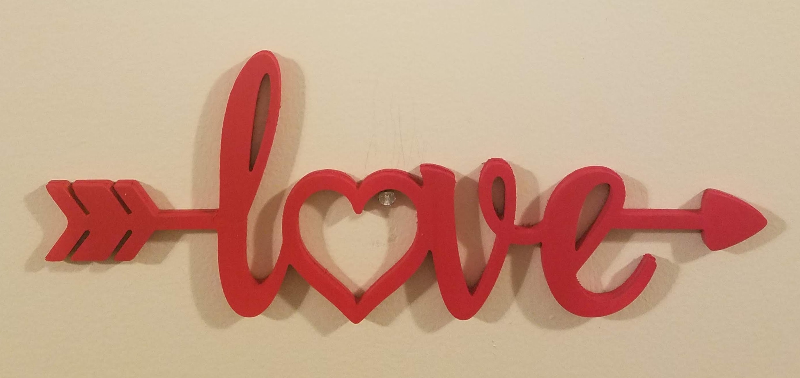 Picture of wooden sign - love word with shooting arrow.