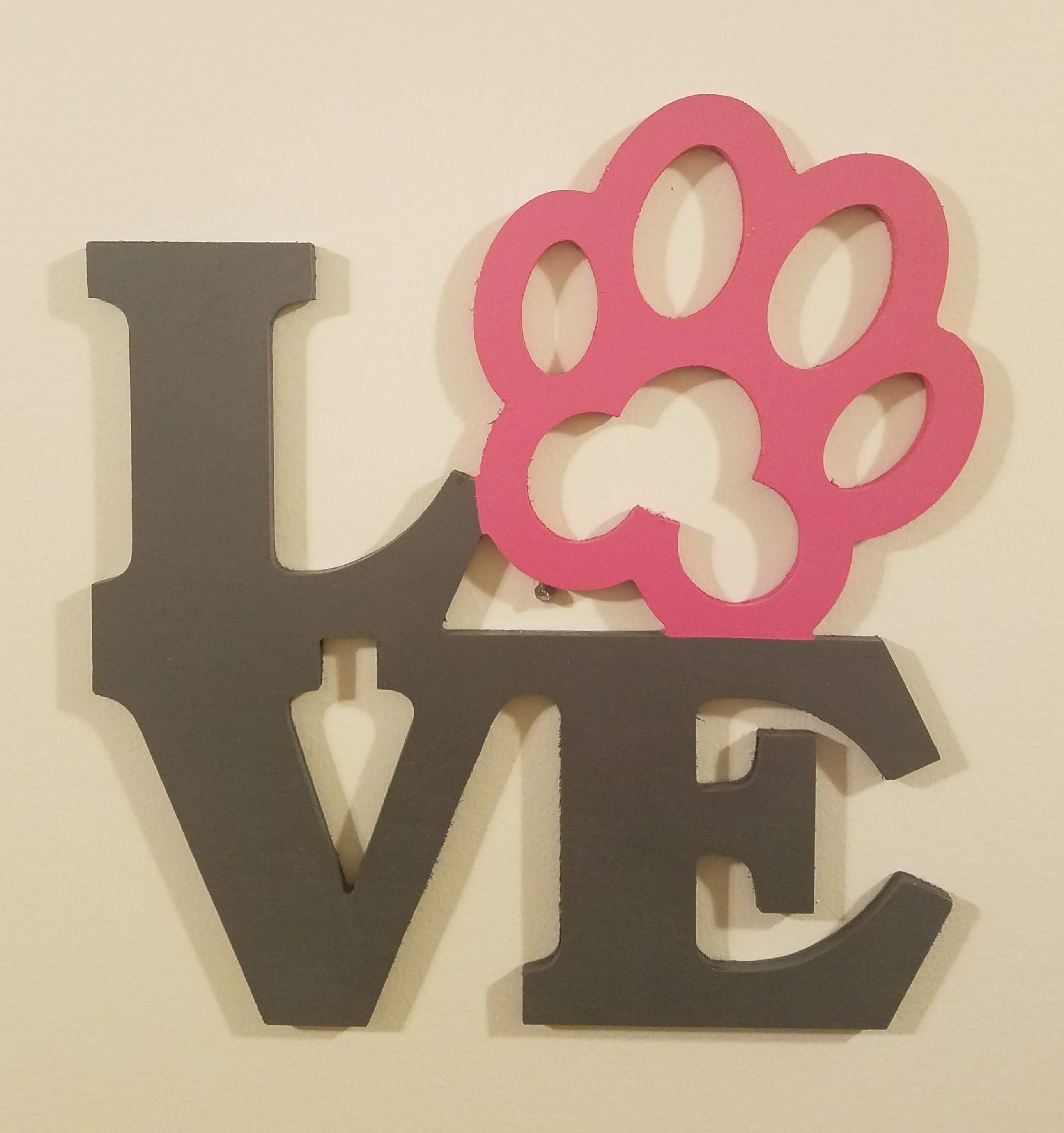 Picture of wooden sign - love word with paw print as the 'O'.