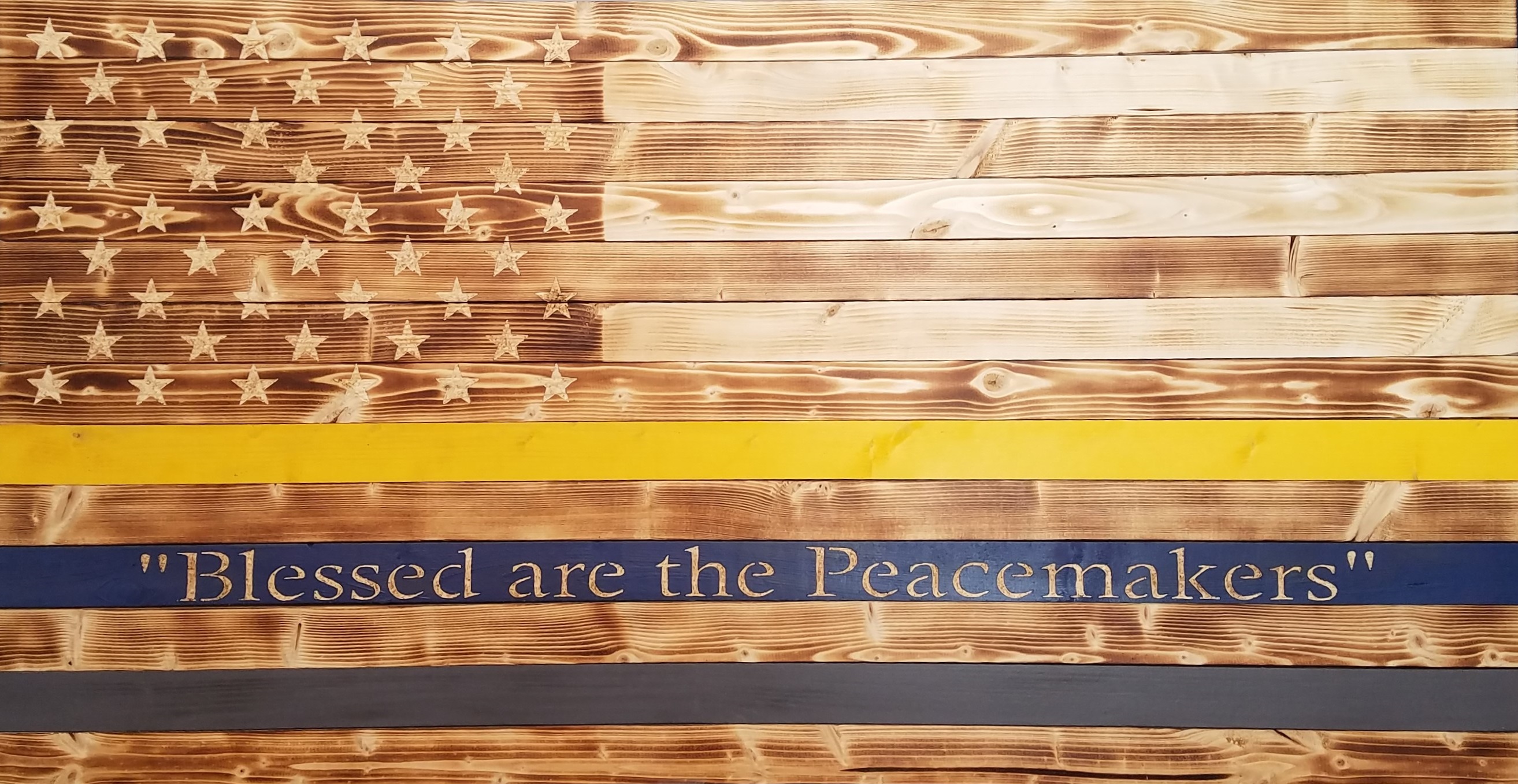 Picture of rustic police flag with customized painted lines: yellow, blue, and gray.